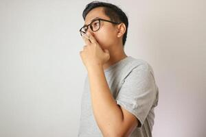 Handsome cool man with Cigarette, going to smoke, isolated on white background, copy space for advertisement. Portrait of asian man in white shirt light cigarette. copy space. Smoking concept. photo