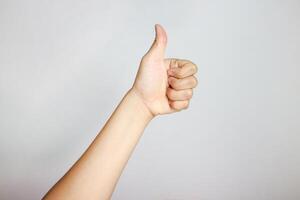 Hand of client show thumb up isolated on white background. Service rating, satisfaction concept. Male hand showing thumb up photo