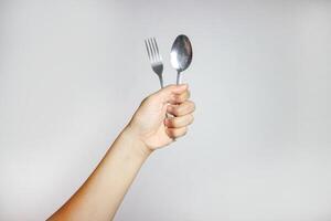 side view of metal fork and spoon on white background photo