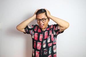 Studio shot of handsome Asian man having headache isolated against white background photo