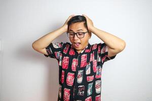 Studio shot of handsome Asian man having headache isolated against white background photo
