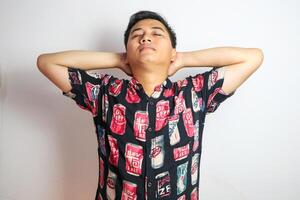 Asian man with glasses relaxing with hands behind head, Vacation concept photo