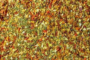 Vibrant and Colored Vegetable Seasoning Mix. A Culinary Canvas of Aromatic Seasoning - Textured Background for Gourmet Cooking. The Harmonious Combination of Fresh Herbs and Spices - Top View photo