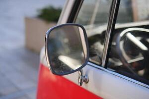 An Impressive CloseUp View of a Vintage Vehicles Side Mirror and Its Intricate Details photo