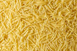 Uncooked Filini Pasta. A Culinary Canvas of Noodles, Creating a Lively and Textured Background for Gourmet Cooking. Dry Pasta. Raw Macaroni - Top View, Flat Lay photo