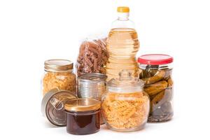 Food Reserves. Canned Food, Spaghetti, Pate, Tuna, Tomato Juice, Pasta, Fish and Grocery - Isolated on White Background. Emergency Food Storage in Case of Crisis. Strategic Food Supplies - Isolation photo