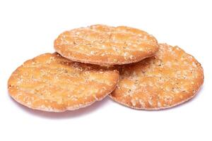 A Heap of Round Salt Crackers with Sesame Isolated on White Background. Dry Snacks - Isolation photo