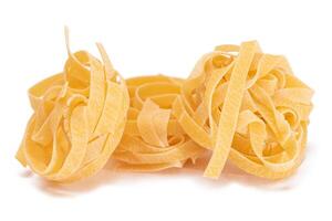 Three Classic Italian Raw Egg Fettuccine - Isolated on White Background. Dry Twisted Uncooked Pasta. Italian Culture and Cuisine. Raw Golden Macaroni Pattern - Isolation photo