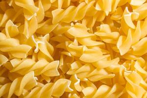 Uncooked Fusilli Pasta. A Culinary Canvas of Spiral Macaroni, Creating a Lively and Textured Background for Gourmet Cooking. Dry Pasta. Raw Macaroni - Top View, Flat Lay photo