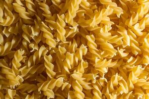 Uncooked Fusilli Pasta. A Culinary Canvas of Spiral Macaroni, Creating a Lively and Textured Background for Gourmet Cooking. Dry Pasta. Raw Macaroni - Top View, Flat Lay photo