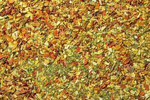 Vibrant and Colored Vegetable Seasoning Mix. A Culinary Canvas of Aromatic Seasoning - Textured Background for Gourmet Cooking. The Harmonious Combination of Fresh Herbs and Spices - Top View photo