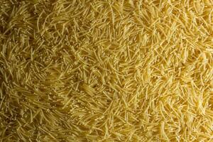 Uncooked Filini Pasta. A Culinary Canvas of Noodles, Creating a Lively and Textured Background for Gourmet Cooking. Dry Pasta. Raw Macaroni - Top View, Flat Lay photo