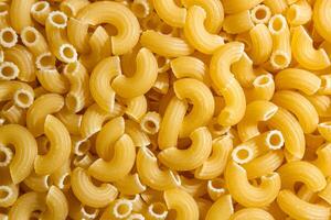 Uncooked Chifferi Rigati Pasta. A Culinary Canvas of Chifferi Rigati, Creating a Lively and Textured Background for Gourmet Cooking. Dry Pasta. Raw Macaroni - Top View, Flat Lay photo
