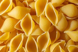 Uncooked Conchiglie Pasta. A Culinary Canvas of Conchiglie Macaroni, Creating a Lively and Textured Background for Gourmet Cooking. Dry Pasta. Raw Macaroni - Top View, Flat Lay photo