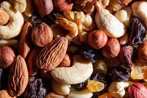 Mixed Nuts. Almonds, Walnuts, Cashews, Peanuts, Hazelnuts, Dried Prunes and Raisins. Different Nut Mix. Background from Various Nuts and Dried Fruits photo