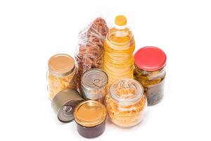Food Reserves. Canned Food, Spaghetti, Pate, Tuna, Tomato Juice, Pasta, Fish and Grocery - Isolated on White Background. Emergency Food Storage in Case of Crisis. Strategic Food Supplies - Isolation photo