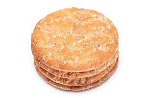 A Stack of Round Salt Crackers with Sesame Isolated on White Background. Dry Snacks - Isolation photo