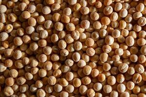 Uncooked Yellow Polished Peas Background. A Culinary Canvas of Dry Yellow Peas, Creating a Lively and Textured Background for Gourmet Cooking. Scattered Raw Polished Peas. Healthy Eating Ingredients photo