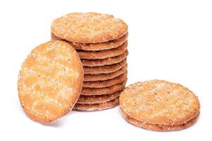 A Stack of Round Salt Crackers with Sesame Isolated on White Background. Dry Snacks - Isolation photo