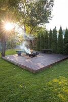 Outdoor Wooden Deck with Central Fire Pit and Rustic Benches photo