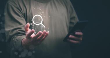Information search technology, search engine optimization, male hand using a smartphone to search information, using the search bar function on your website photo