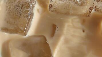 slow motion of falling ice cubes in a ice late coffee video