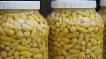 Delicious Jars of Pickled Garlic Cloves Preserved in Vinegar for a Tasty Experience video