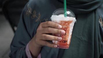 A cool and refreshing drink held in hand, ideal for delightful summer enjoyment and relaxation. video