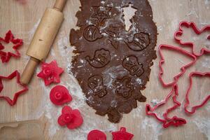 Gingerbread dough for Christmas cookies and cookie cutters.Christmass card and advent calendar concept. Top view.High quality photo