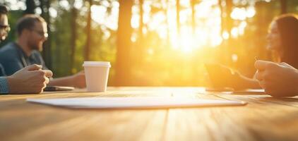 Collaborative team meeting outdoors, discussing strategies with coffee. warm sunlight creates positive atmosphere for brainstorming and teamwork photo