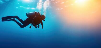 Diver exploring deep blue waters, surrounded by vibrant marine life and sunlight filtering through surface, creating serene underwater atmosphere photo