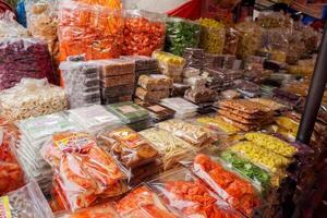Souvenir shops at Bukittinggi Market display a wide array of local snacks. photo
