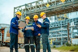 Group of workers teamwork Industry in oil refinery equipment Check and check the condition of the machinery system , Engineering concept. photo