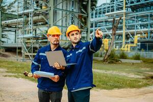 Teamwork Industry in oil refinery equipment Check and check the condition of the machinery system , Engineering concept. photo