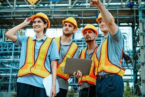 Group of workers teamwork Industry in oil refinery equipment Check and check the condition of the machinery system , Engineering concept. photo