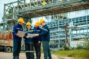 Group of workers teamwork Industry in oil refinery equipment Check and check the condition of the machinery system , Engineering concept. photo