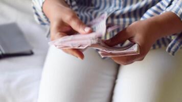 woman holds large stack of 200 Turkish lira bills in front of her, spreads it with a fan and shows it to the camera, a lot of money, but little value, high inflation in Turkey video