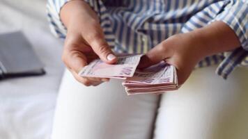 woman holds large stack of 200 Turkish lira bills in front of her, spreads it with a fan and shows it to the camera, a lot of money, but little value, high inflation in Turkey video