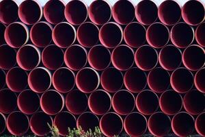 Metal pipes stacked on top of each other background. Forming a r photo