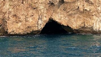 Mysterious Coastal Cave Entrance Explored at Sunset on the Mediterranean Sea video