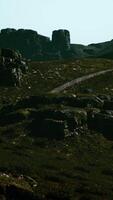 A view of some rocks and grass on a hill video
