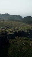 A view of a rocky mountain with a foggy sky video
