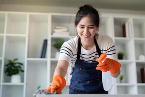 Professional Cleaner Smiling While Sanitizing Kitchen Surface for Tidy Home Concept photo