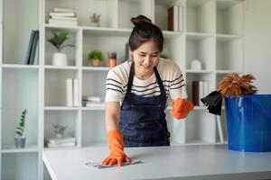 Efficient Cleaning Service Worker Completing Task with Orange Gloves for Spotless Finish photo