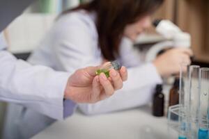 Researcher Analyzing Specimen Under Microscope in Science Lab photo