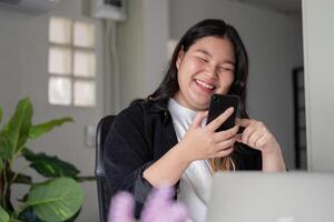 Joyful Overweight Worker Using Smartphone for Fast Workplace Communication photo