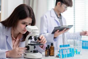 Microbiologist Using Microscope for Research in Modern Lab Setting photo