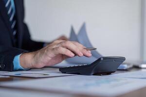Finance Auditor Calculating Figures for Report Validation photo
