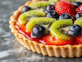 Delicious fresh fruit tart with kiwi, strawberries, and blueberries photo