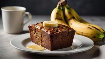 A slice of banana bread with a banana and a cup of coffee on a plate. photo